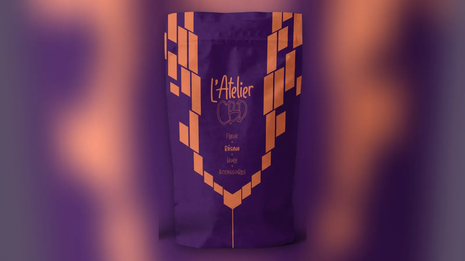 Pochon L'Atelier CBD violet à motifs orange, photographié de face sur un fond flouté aux mêmes couleurs